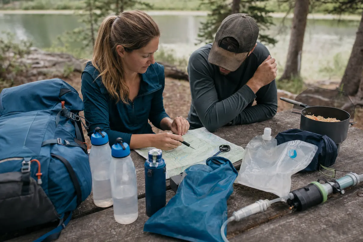 Backpackers measuring the dry segment between a final water point, campsite, and next morning source on a generic route plan - first trip water planning | KnowOutdoor