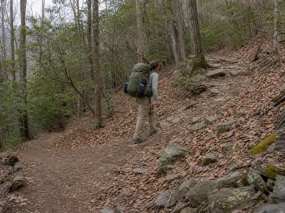 Backpacker comparing steady loaded walking on level trail with a controlled climb - backpacking exercise intensity | KnowOutdoor